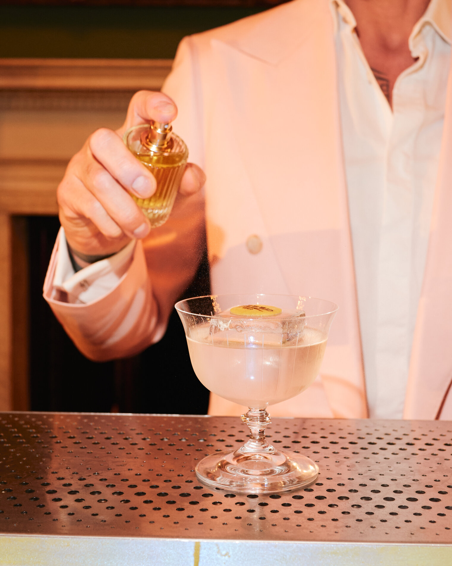 Close-up of bespoke Aventus cocktail finished with house-made essence spray by Philoxenia Events for Creed corporate event