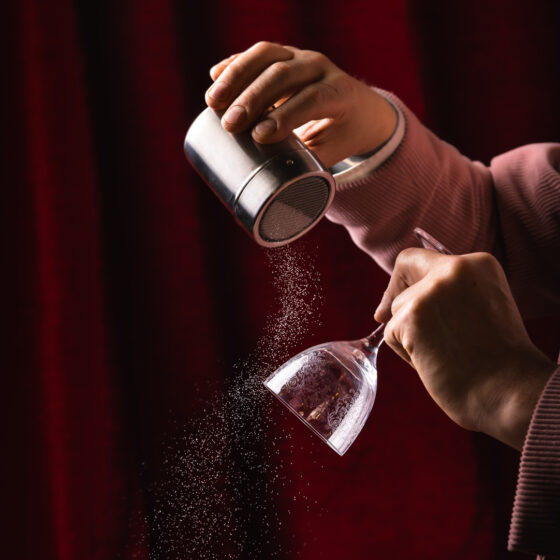 Philoxenia Events London senior mixologist preparing a bespoke cocktail for a luxury event with fresh, high-quality ingredients